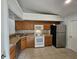 Full view of kitchen with wood cabinets and appliances at 4520 Summergrove Ave, Orlando, FL 32812