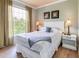 Comfortable bedroom featuring a full-sized bed, side tables with lamps and lots of natural light at 1301 Tuscan Ter # 9401, Davenport, FL 33896