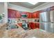 Well-equipped kitchen featuring stainless steel appliances, granite countertops, and ample cabinet space at 1301 Tuscan Ter # 9401, Davenport, FL 33896