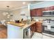 Kitchen with granite counters, stainless appliances and open layout to the dining area at 1301 Tuscan Ter # 9401, Davenport, FL 33896