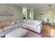 Inviting living area showcasing a large sectional sofa and an ottoman near the dining area at 1301 Tuscan Ter # 9401, Davenport, FL 33896