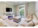 Comfortable living room featuring a large sectional sofa, modern fireplace, and sliding glass doors to the balcony at 1301 Tuscan Ter # 9401, Davenport, FL 33896