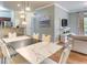 Open-concept kitchen and dining area with stainless steel appliances and a marble-top dining table at 1301 Tuscan Ter # 9401, Davenport, FL 33896