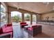 Outdoor covered lounge area featuring comfortable seating and a bar for entertaining guests at 1301 Tuscan Ter # 9401, Davenport, FL 33896