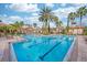A view of the pool with clear blue water, palm trees, and pool furniture for relaxation at 1301 Tuscan Ter # 9401, Davenport, FL 33896