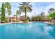 Luxurious swimming pool area with poolside seating and palm trees, perfect for relaxation and recreation at 1301 Tuscan Ter # 9401, Davenport, FL 33896