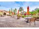 Inviting outdoor area with tables and chairs near the community pool under blue sky at 1301 Tuscan Ter # 9401, Davenport, FL 33896
