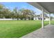 Lush backyard showcasing a covered patio with brick pavers and a well-maintained lawn at 3022 Peel Ave, Orlando, FL 32806