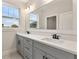Bathroom with a double sink vanity and large mirror at 3022 Peel Ave, Orlando, FL 32806