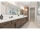 Luxury bathroom with a double vanity, granite countertop, wood cabinets, and a glass-enclosed shower at 3022 Peel Ave, Orlando, FL 32806
