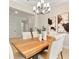 Cozy dining room with wood table, modern chairs, stylish light fixture, and elegant wall art at 3022 Peel Ave, Orlando, FL 32806