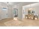 Inviting entryway featuring light hardwood floors, a dining room, a study, and a neutral-colored rug at 3022 Peel Ave, Orlando, FL 32806