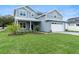 Beautiful two-story house with well-maintained green lawn and attractive landscaping, enhancing curb appeal at 3022 Peel Ave, Orlando, FL 32806
