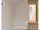 Hallway showing steps to a carpeted area and a doorway, featuring neutral wall colors at 3022 Peel Ave, Orlando, FL 32806