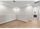 Bright hallway with hardwood floors leading to a full bathroom at 3022 Peel Ave, Orlando, FL 32806