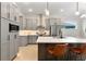 Modern kitchen featuring gray cabinetry, a center island with seating, and stainless steel appliances at 3022 Peel Ave, Orlando, FL 32806