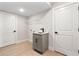 Functional laundry room with a utility sink, storage cabinet, and laminate floors at 3022 Peel Ave, Orlando, FL 32806