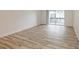 Living room with wood-look floors and access to balcony at 4213 S Semoran Blvd # 9, Orlando, FL 32822