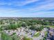 Aerial view of a residential neighborhood with houses and lush green trees at 2907 Willow Oak Ct, Kissimmee, FL 34744