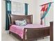 Bright bedroom featuring a queen-size bed and large window at 2907 Willow Oak Ct, Kissimmee, FL 34744
