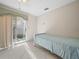 Bedroom with twin bed and access to backyard at 2907 Willow Oak Ct, Kissimmee, FL 34744