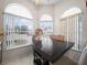 Bright breakfast nook with three chairs and arched windows at 2907 Willow Oak Ct, Kissimmee, FL 34744