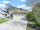 House exterior featuring a two-car garage and well-maintained lawn at 2907 Willow Oak Ct, Kissimmee, FL 34744