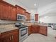 Modern kitchen with granite countertops and wood cabinets at 2907 Willow Oak Ct, Kissimmee, FL 34744