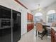 Kitchen with stainless steel refrigerator and wood cabinets at 2907 Willow Oak Ct, Kissimmee, FL 34744