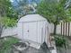 White storage shed with double doors in backyard at 2907 Willow Oak Ct, Kissimmee, FL 34744