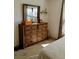 Bedroom with large dresser and mirror reflecting light at 2292 Richey Rd, The Villages, FL 32163