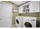 Laundry room with washer, dryer and upper cabinets at 2063 Ashboro Pl, Bartow, FL 33830