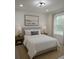 Cozy bedroom with neutral tones, a large window, and stylish furnishings, creating a relaxing retreat at 3245 Se 142Nd Pl, Summerfield, FL 34491