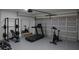 Spacious garage transformed into a well-equipped home gym with modern fitness equipment and ample space at 3245 Se 142Nd Pl, Summerfield, FL 34491