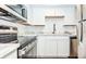 Modern kitchen with stainless steel appliances, white cabinets, and stone countertops at 948 Lake Destiny Rd # G, Altamonte Springs, FL 32714