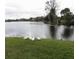 Scenic lake view featuring lush greenery and an assortment of beautiful birds at 948 Lake Destiny Rd # G, Altamonte Springs, FL 32714