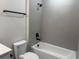 Simple bathroom with gray tile and a shower/tub combo at 336 Center Lake Ln # A-2, Oviedo, FL 32765