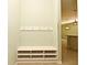 White bench with cubbies and hooks in a light green room at 1155 Merion Dr, Mount Dora, FL 32757