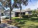 Single-story home with attached garage and well-manicured lawn at 251 Rock Springs Dr, Poinciana, FL 34759