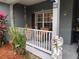 Inviting front porch with seating and landscaping at 251 Rock Springs Dr, Poinciana, FL 34759
