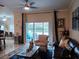 Living room with sliding glass doors leading to patio and pool at 251 Rock Springs Dr, Poinciana, FL 34759