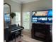 Living area with fireplace, large TV, and electronic keyboard at 251 Rock Springs Dr, Poinciana, FL 34759