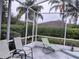 Relaxing screened porch with patio furniture, overlooking the backyard at 251 Rock Springs Dr, Poinciana, FL 34759