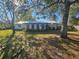 Spacious backyard with mature trees and a single-story home at 4751 Meadow Dr, Saint Cloud, FL 34772