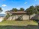 Landscaped backyard with a view of the lake and a wooden fence at 12943 Se Sunset Harbor Rd, Weirsdale, FL 32195