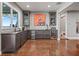 Modern basement bar with dark cabinetry, quartz countertops and wine cooler at 12943 Se Sunset Harbor Rd, Weirsdale, FL 32195