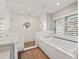 Spa-like bathroom with soaking tub, walk-in shower, and white tile at 12943 Se Sunset Harbor Rd, Weirsdale, FL 32195