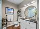 Modern bathroom with a large vanity and a walk-in shower at 12943 Se Sunset Harbor Rd, Weirsdale, FL 32195