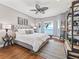 Main bedroom with water views, king-size bed, and wood floors at 12943 Se Sunset Harbor Rd, Weirsdale, FL 32195