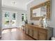Bright entryway with wood floors and elegant console table at 12943 Se Sunset Harbor Rd, Weirsdale, FL 32195
